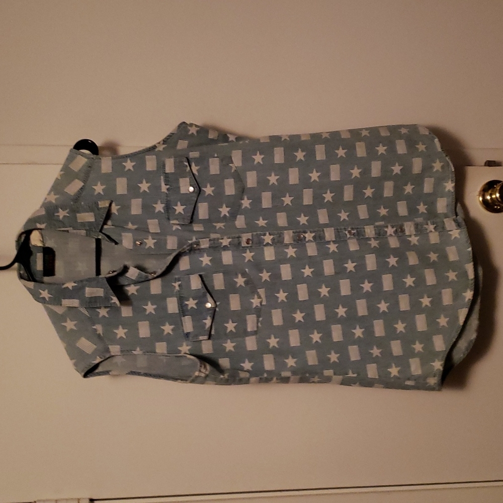 Blue sleeveless shirt with white stars and flags.Bin#5